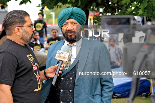 A member of the community is interviewed by media during a protest at an international students' encampment in Brampton, Canada, on Septembe...