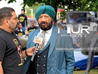 A member of the community is interviewed by media during a protest at an international students' encampment in Brampton, Canada, on Septembe...