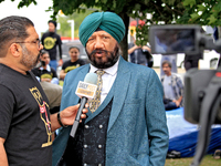 A member of the community is interviewed by media during a protest at an international students' encampment in Brampton, Canada, on Septembe...