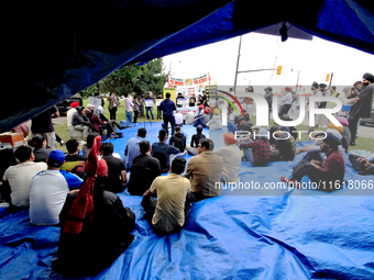 Participants sit and listen to speakers during a protest rally at an international students' encampment in Brampton, Canada, on September 28...