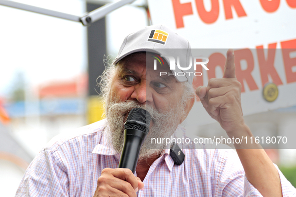 Retired lawyer and local resident Amarjeet Sidhu speaks to participants during a protest rally at an international students' encampment in B...