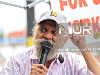 Retired lawyer and local resident Amarjeet Sidhu speaks to participants during a protest rally at an international students' encampment in B...