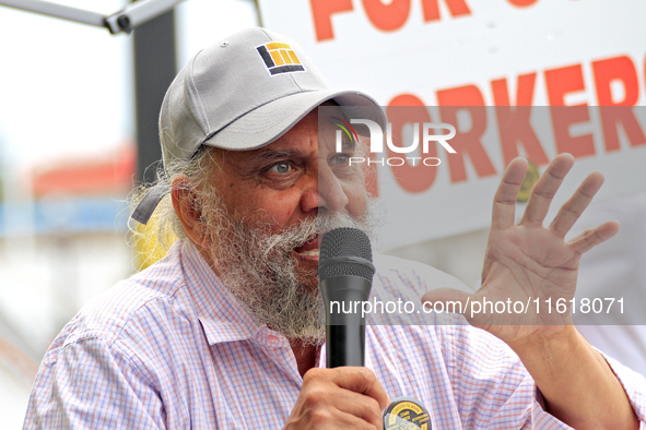 Retired lawyer and local resident Amarjeet Sidhu speaks to participants during a protest rally at an international students' encampment in B...