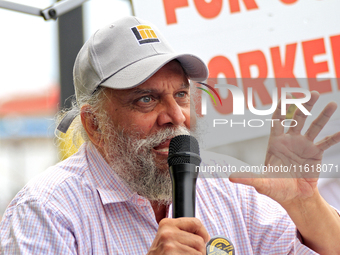 Retired lawyer and local resident Amarjeet Sidhu speaks to participants during a protest rally at an international students' encampment in B...