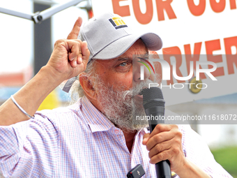 Retired lawyer and local resident Amarjeet Sidhu speaks to participants during a protest rally at an international students' encampment in B...