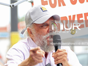 Retired lawyer and local resident Amarjeet Sidhu speaks to participants during a protest rally at an international students' encampment in B...