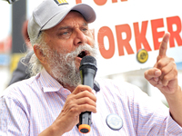 Retired lawyer and local resident Amarjeet Sidhu speaks to participants during a protest rally at an international students' encampment in B...