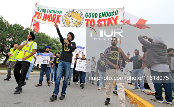 Participants walk during a protest rally at an international students' encampment in Brampton, Canada, on September 28, 2024. The encampment...