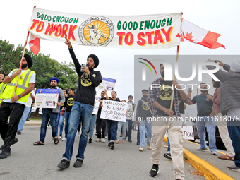 Participants walk during a protest rally at an international students' encampment in Brampton, Canada, on September 28, 2024. The encampment...