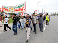 Participants walk along Queen Street during a protest rally at an international students' encampment in Brampton, Canada, on September 28, 2...