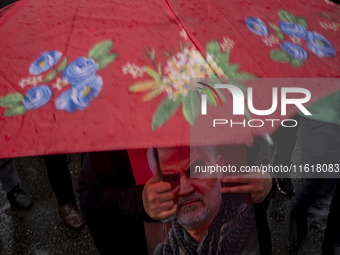 A veiled Iranian protester holds a portrait of the former commander of the Islamic Revolutionary Guard Corps' (IRGC) Quds Force, General Qas...