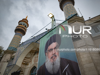 A billboard featuring a portrait of Lebanon's Hezbollah Secretary General, Hassan Nasrallah, who was killed in an Israeli air strike, stands...