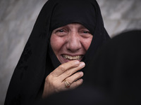 A veiled woman mourns while taking part in a protest gathering to condemn an Israeli air strike against Hezbollah's headquarters in the subu...