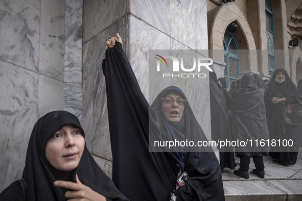 A veiled Iranian woman shouts anti-Israeli and anti-U.S. slogans while taking part in a protest gathering to condemn an Israeli air strike a...