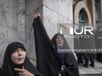 A veiled Iranian woman shouts anti-Israeli and anti-U.S. slogans while taking part in a protest gathering to condemn an Israeli air strike a...