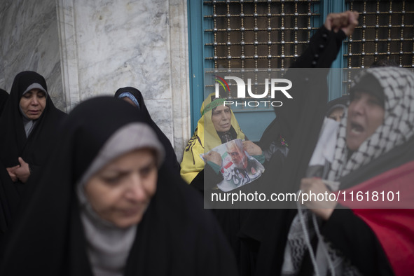 An Iranian woman holds a portrait of the former commander of the Islamic Revolutionary Guard Corps' (IRGC) Quds Force, General Qassem Soleim...