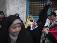 An Iranian woman holds a portrait of the former commander of the Islamic Revolutionary Guard Corps' (IRGC) Quds Force, General Qassem Soleim...