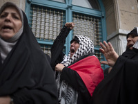 A female protester wearing a Palestinian scarf shouts anti-U.S. and anti-Israeli slogans during a protest gathering to condemn an Israeli ai...