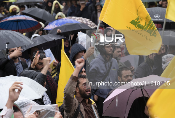 An Iranian protester shouts anti-Israeli and anti-U.S. slogans while mourning during a protest gathering to condemn an Israeli air strike ag...