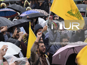 An Iranian protester shouts anti-Israeli and anti-U.S. slogans while mourning during a protest gathering to condemn an Israeli air strike ag...