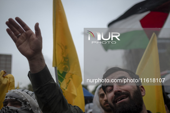 An Iranian protester shouts anti-Israeli and anti-U.S. slogans while mourning during a protest gathering to condemn an Israeli air strike ag...