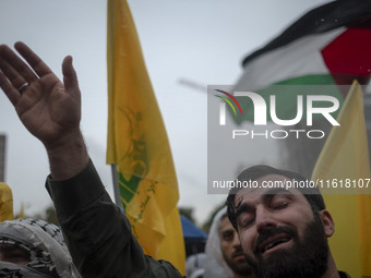 An Iranian protester shouts anti-Israeli and anti-U.S. slogans while mourning during a protest gathering to condemn an Israeli air strike ag...