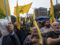 Iranian protesters beat themselves while taking part in a protest gathering to condemn an Israeli air strike against Hezbollah's headquarter...