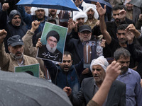 An Iranian protester holds up a portrait of Lebanon's Hezbollah Secretary General, Hassan Nasrallah, during a protest gathering to condemn a...