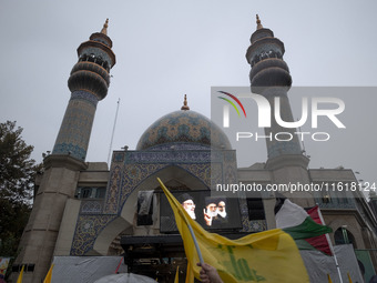 A display features a portrait of Lebanon's Hezbollah Secretary General, Hassan Nasrallah, during a protest gathering to condemn an Israeli a...