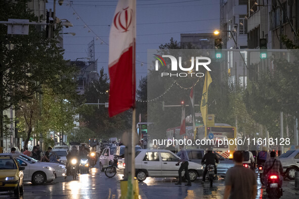 An avenue is decorated with a Lebanon's Hezbollah flag and an Iranian flag during a protest gathering to condemn an Israeli air strike again...