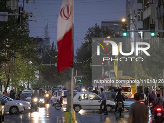 An avenue is decorated with a Lebanon's Hezbollah flag and an Iranian flag during a protest gathering to condemn an Israeli air strike again...