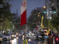 An avenue is decorated with a Lebanon's Hezbollah flag and an Iranian flag during a protest gathering to condemn an Israeli air strike again...