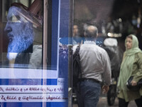 Iranian people walk past a portrait of Lebanon's Hezbollah Secretary General, Hassan Nasrallah, in Tehran, Iran, on September 28, 2024. Leba...