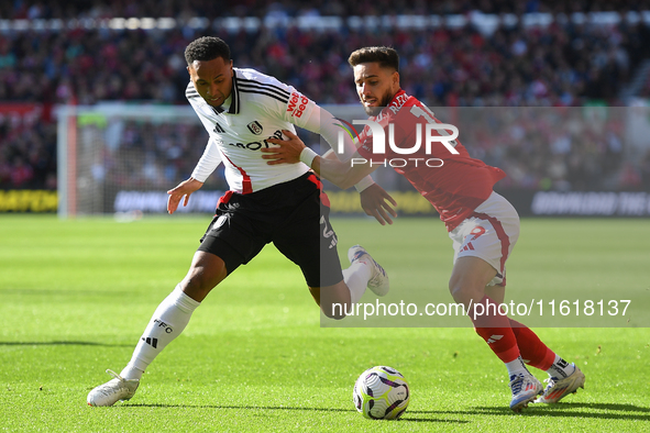 Alex Moreno of Nottingham Forest battles with Kenny Tete of Fulham during the Premier League match between Nottingham Forest and Fulham at t...