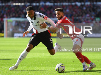 Alex Moreno of Nottingham Forest battles with Kenny Tete of Fulham during the Premier League match between Nottingham Forest and Fulham at t...