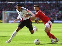 Alex Moreno of Nottingham Forest battles with Kenny Tete of Fulham during the Premier League match between Nottingham Forest and Fulham at t...