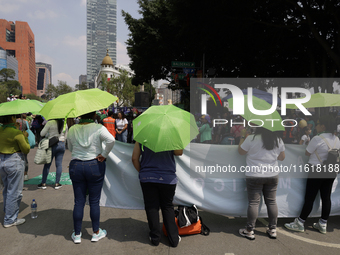 Feminist groups with umbrellas march from the Glorieta de las Mujeres que Luchan to the Zocalo in Mexico City, Mexico, on September 28, 2024...