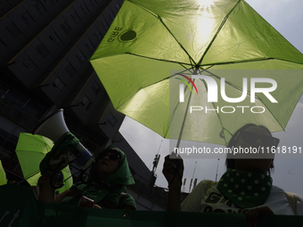 Feminist groups with umbrellas march from the Glorieta de las Mujeres que Luchan to the Zocalo in Mexico City, Mexico, on September 28, 2024...