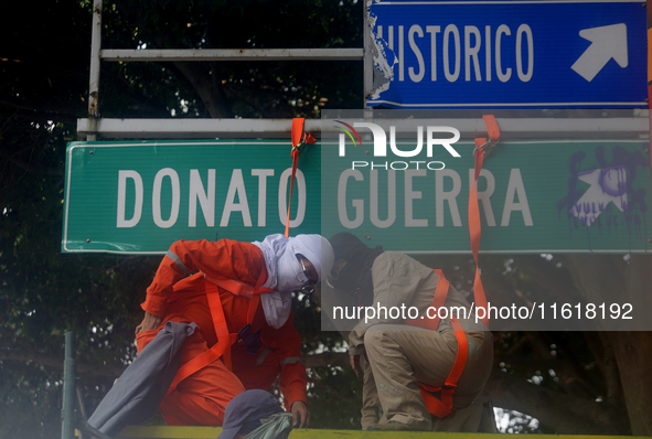 Feminist women intervene on road signs in Mexico City, Mexico, on September 28, 2024, where dozens of women march from the Glorieta de las M...