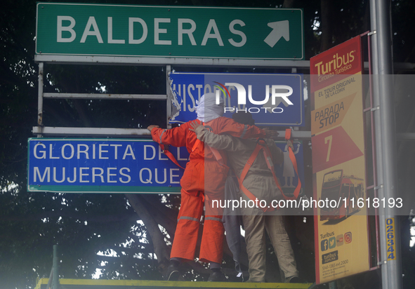 Feminist women intervene on road signs in Mexico City, Mexico, on September 28, 2024, where dozens of women march from the Glorieta de las M...