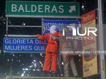 Feminist women intervene on road signs in Mexico City, Mexico, on September 28, 2024, where dozens of women march from the Glorieta de las M...