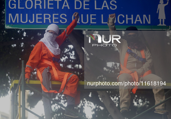 Feminist women intervene on road signs in Mexico City, Mexico, on September 28, 2024, where dozens of women march from the Glorieta de las M...