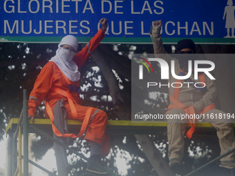 Feminist women intervene on road signs in Mexico City, Mexico, on September 28, 2024, where dozens of women march from the Glorieta de las M...