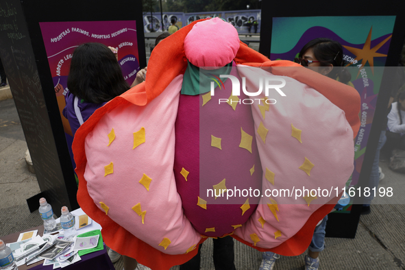 A feminist woman disguises herself as a vulva in Mexico City, Mexico, on September 28, 2024, where dozens of women march from the Glorieta d...