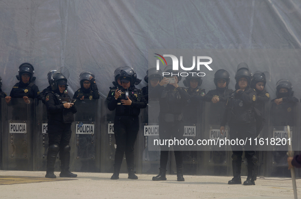 Policewomen guard women marching in Mexico City, Mexico, on September 28, 2024, from the Glorieta de las Mujeres que Luchan to the Zocalo on...