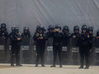 Policewomen guard women marching in Mexico City, Mexico, on September 28, 2024, from the Glorieta de las Mujeres que Luchan to the Zocalo on...