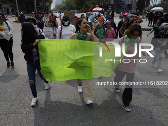 Various feminist collectives march in Mexico City, Mexico, on September 28, 2024, from various points to the capital's Zocalo to mark the Gl...