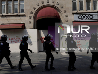 Policewomen guard women marching in Mexico City, Mexico, on September 28, 2024, from the Glorieta de las Mujeres que Luchan to the Zocalo on...