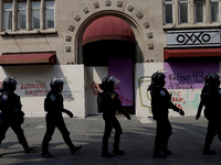 Policewomen guard women marching in Mexico City, Mexico, on September 28, 2024, from the Glorieta de las Mujeres que Luchan to the Zocalo on...