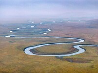 An aerial photo taken in Hulunbuir, China, on September 28, 2024, shows the winding Mogoler River passing through the grassland during autum...